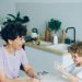 Mother and son having fun with flour cooking home-made cookies in kitchen